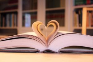 book laying open with pages made into a heart